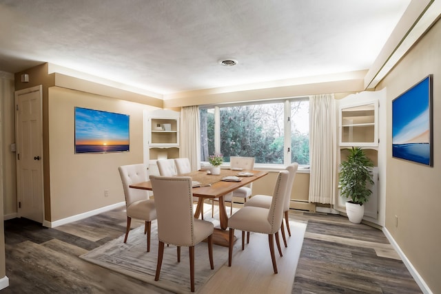 dining space featuring dark wood-type flooring