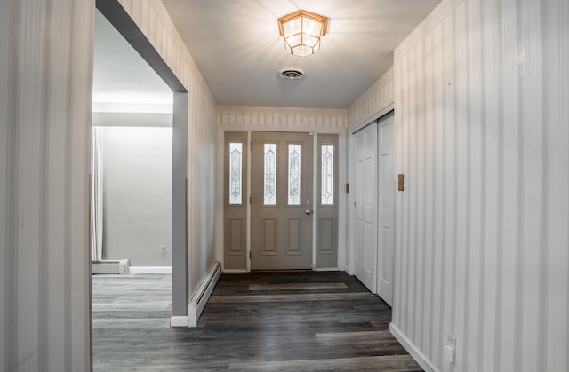 entrance foyer featuring dark wood-type flooring and a baseboard heating unit