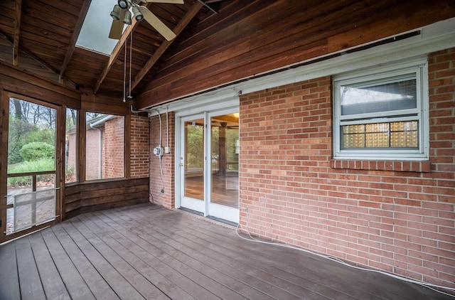 unfurnished sunroom featuring lofted ceiling with beams and ceiling fan