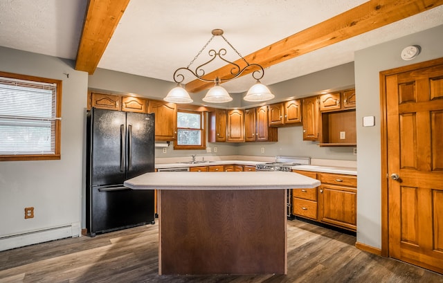 kitchen featuring a baseboard heating unit, white electric range oven, a kitchen island, decorative light fixtures, and black fridge