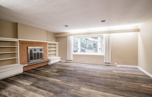 unfurnished living room with baseboard heating, dark hardwood / wood-style floors, and a brick fireplace