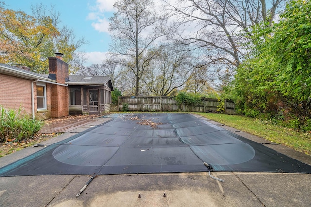 view of pool featuring a sunroom