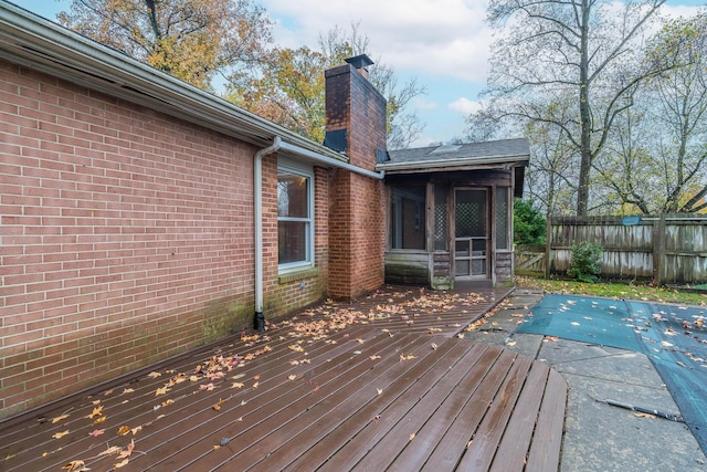 deck featuring a covered pool and a sunroom