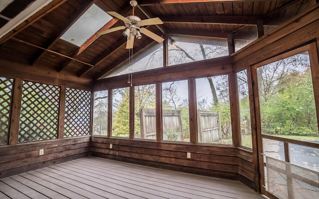 unfurnished sunroom with wood ceiling, ceiling fan, and vaulted ceiling with beams