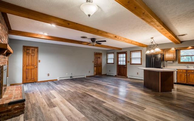 kitchen with black fridge, a baseboard radiator, and a kitchen island