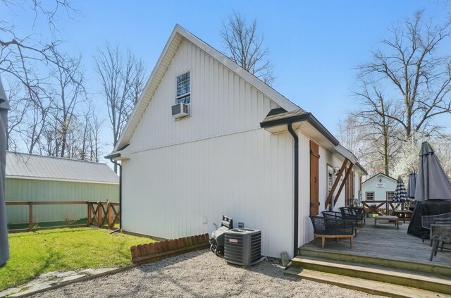 9436 Cottonwood Dr, Huntsville, OH 43324 - rear view of house featuring a lawn, cooling unit, central AC, and a wooden deck