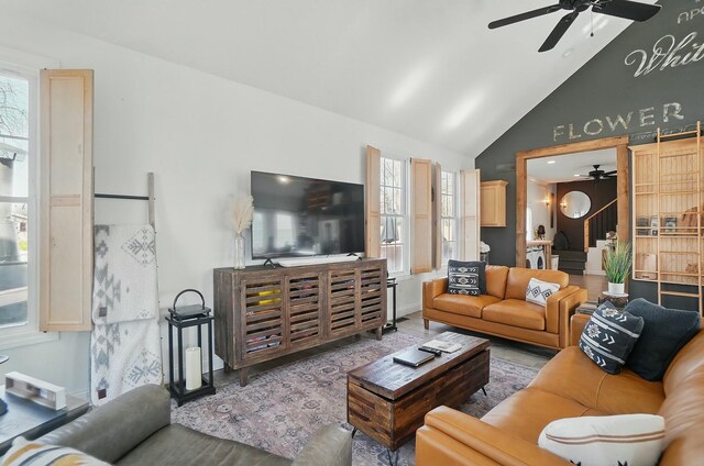 9436 Cottonwood Dr, Huntsville, OH 43324 - living room featuring baseboards, high vaulted ceiling, and ceiling fan