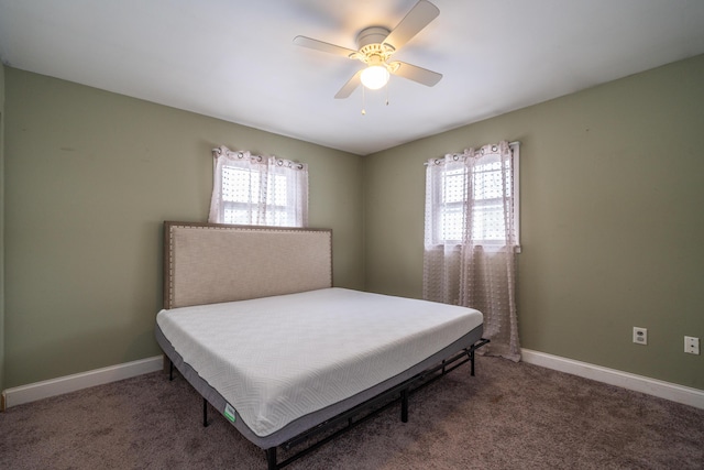 bedroom featuring multiple windows, carpet, and baseboards