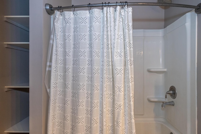 bathroom with shower / bath combo with shower curtain