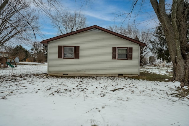 snow covered property featuring crawl space