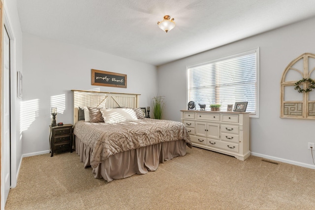 bedroom featuring light carpet