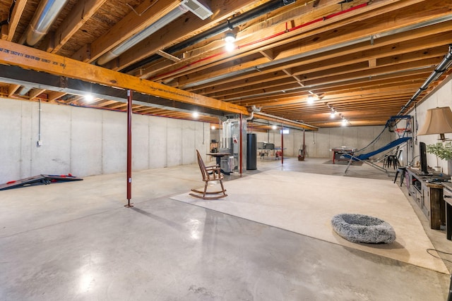 basement with water heater and heating unit