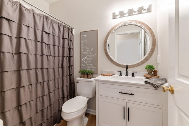 bathroom featuring hardwood / wood-style flooring, vanity, and toilet