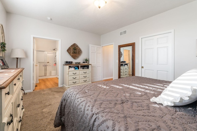 carpeted bedroom with ensuite bath