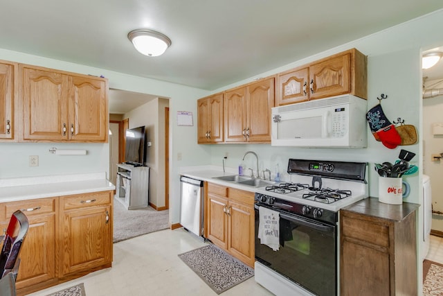 120 Garman Ave, Celina, OH 45822 - kitchen featuring white microwave, range with gas stovetop, dishwasher, a sink, and light floors