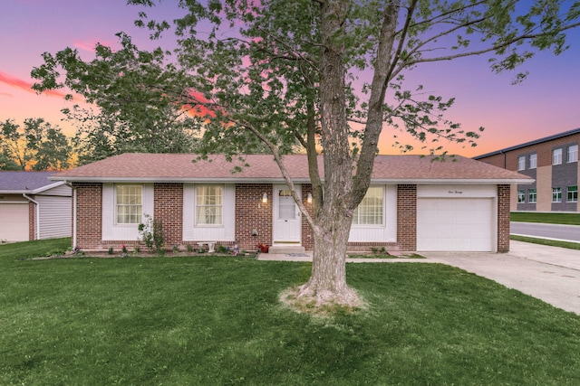 120 Garman Ave, Celina, OH 45822 - ranch-style house with brick siding, a garage, driveway, and a yard