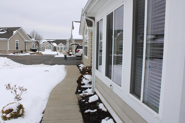 view of snowy exterior with a residential view