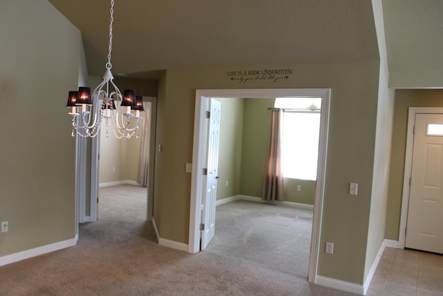 unfurnished dining area featuring light colored carpet and baseboards