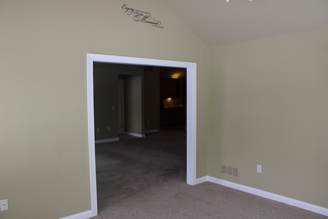 unfurnished room with carpet floors, lofted ceiling, visible vents, and baseboards