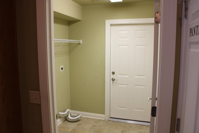 laundry room with laundry area, baseboards, and electric dryer hookup