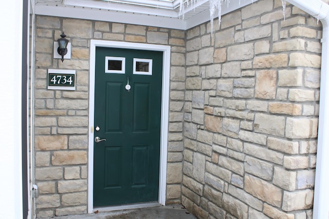 view of exterior entry featuring stone siding