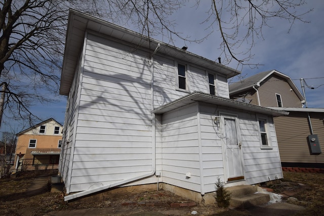 back of property featuring entry steps