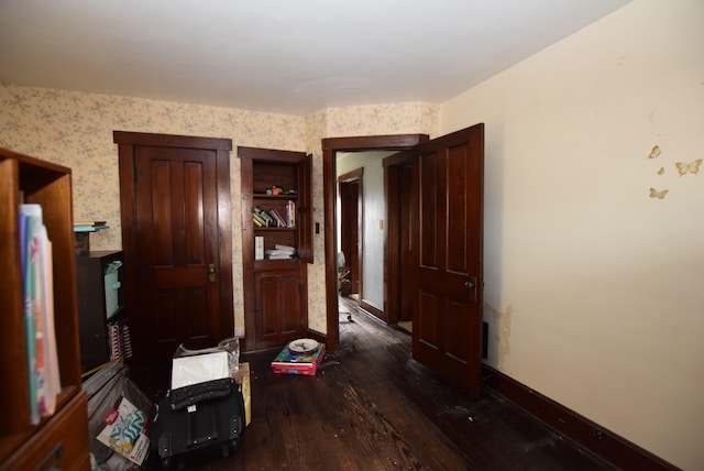 hallway featuring hardwood / wood-style floors and wallpapered walls