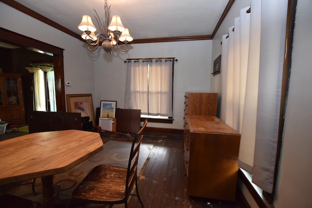 dining room with a chandelier, ornamental molding, hardwood / wood-style flooring, and baseboards