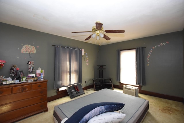 bedroom featuring light colored carpet, ceiling fan, and baseboards