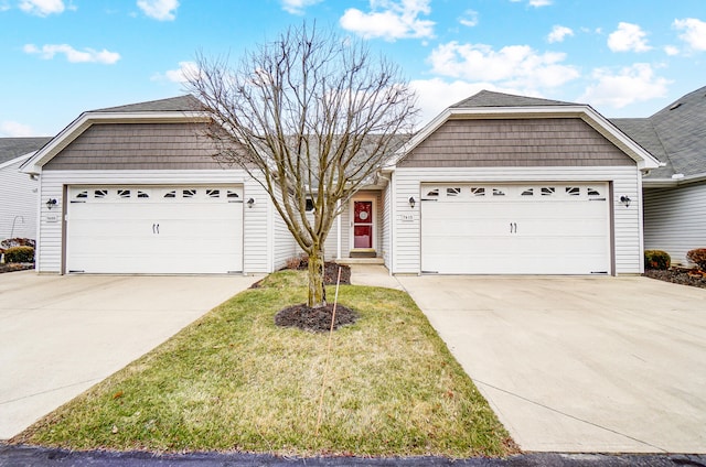 ranch-style house with a garage and a front lawn