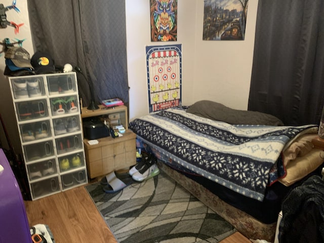 bedroom with wood-type flooring