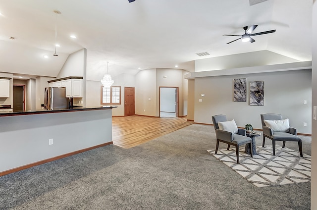 interior space with lofted ceiling, visible vents, light carpet, and baseboards