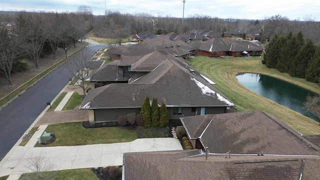 drone / aerial view with a residential view and a water view