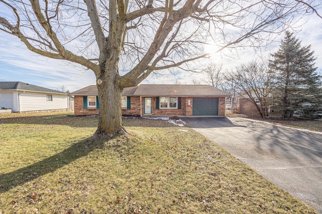 ranch-style home with a garage and a front yard