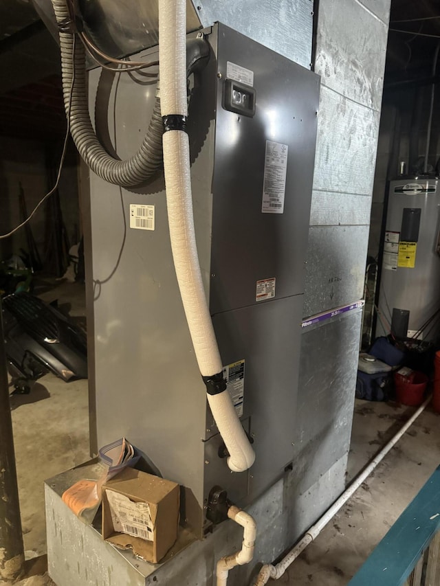 utility room with heating unit and water heater