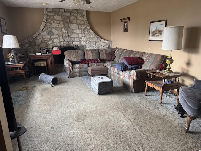 carpeted living area with a ceiling fan and a textured ceiling