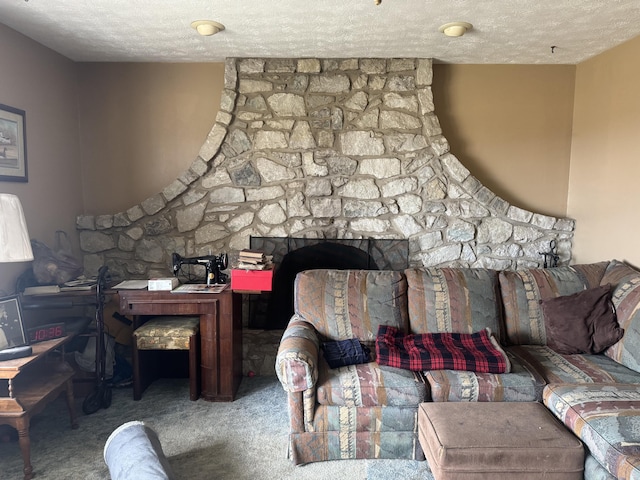 carpeted living room featuring a large fireplace and a textured ceiling