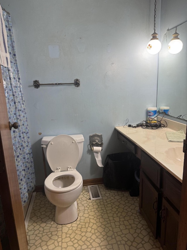 full bathroom with baseboards, visible vents, vanity, and toilet