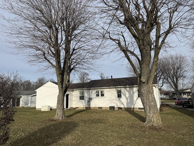 back of property featuring a lawn