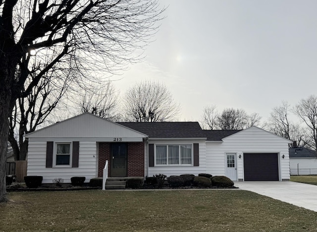 single story home with a garage and a front lawn