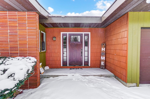 view of snow covered property entrance