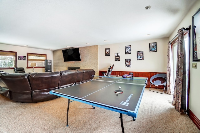 rec room featuring a wainscoted wall and carpet