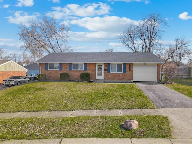 ranch-style house with a front lawn, an attached garage, fence, and driveway