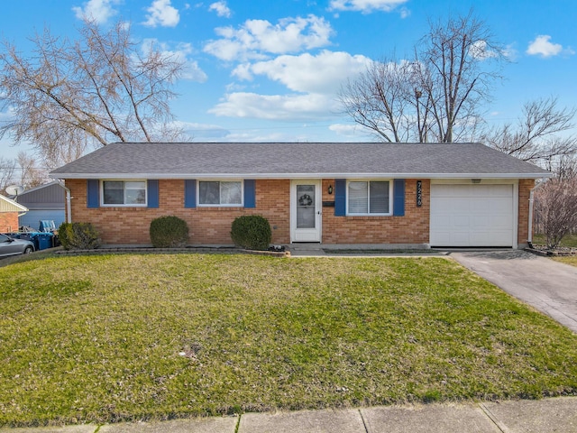 ranch-style house featuring a garage, a front lawn, driveway, and a shingled roof