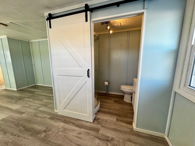 bathroom featuring hardwood / wood-style floors and toilet