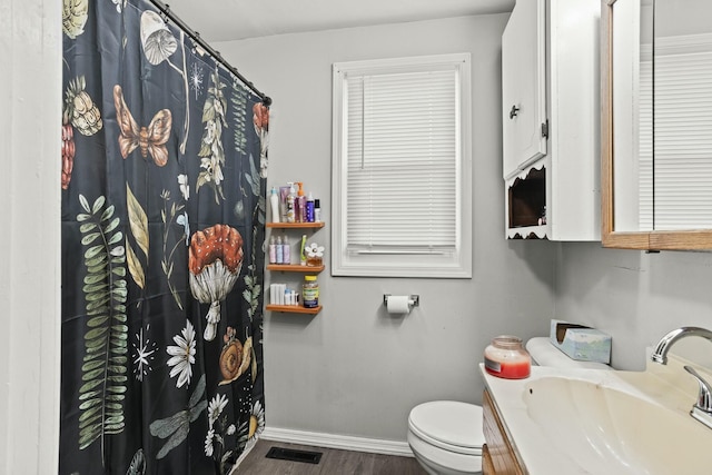 full bathroom with vanity, baseboards, toilet, visible vents, and wood finished floors