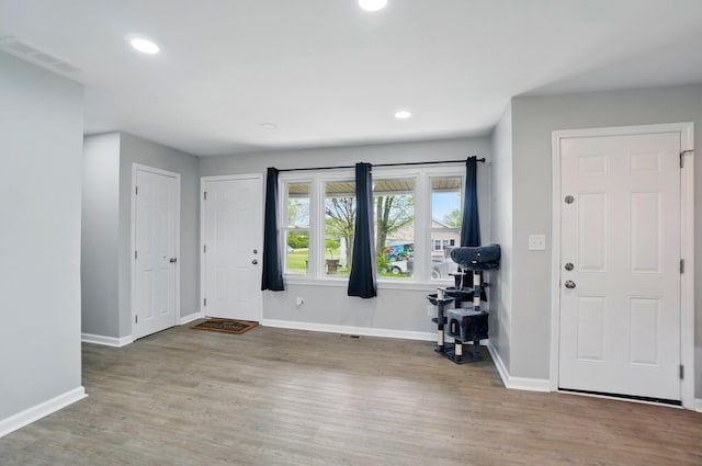 foyer entrance featuring visible vents, recessed lighting, baseboards, and wood finished floors