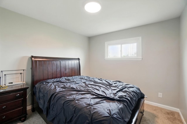 bedroom with baseboards and light carpet