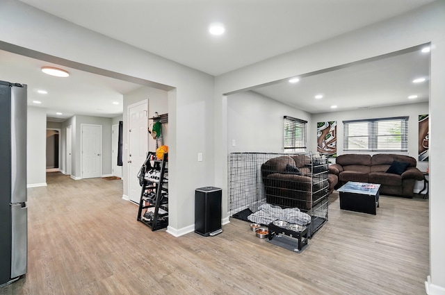 living area featuring recessed lighting, baseboards, and wood finished floors