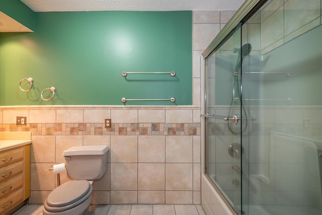 full bath featuring tile walls, toilet, enclosed tub / shower combo, a textured ceiling, and vanity